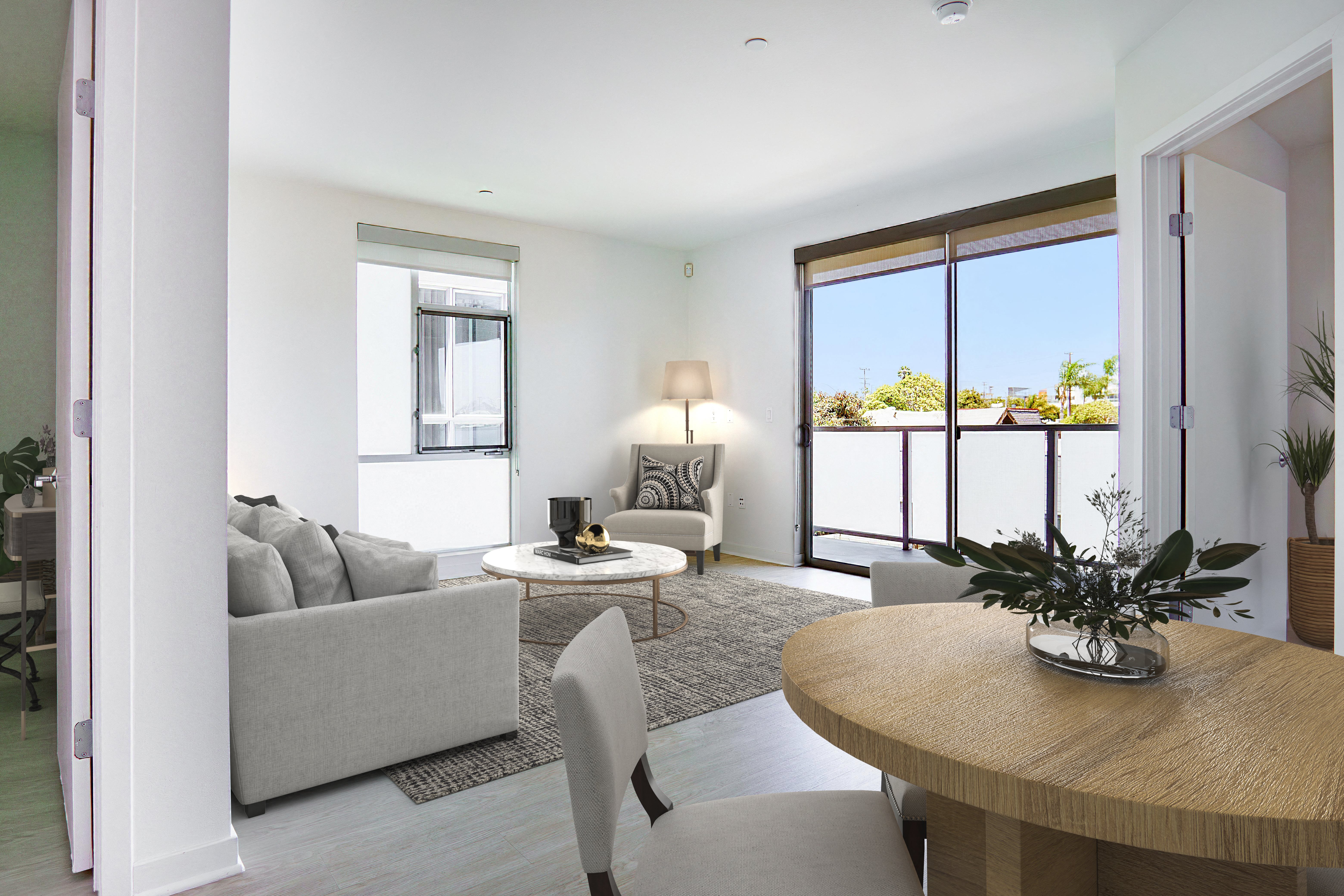 a living room with white walls and a wooden table and chairs